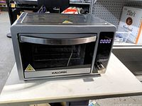 Front view of Kalorik air fryer oven showing controls and door