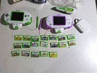 Overview of both consoles, stylus pen, battery pack and 19 game cartridges