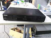 Front view of Panasonic DVD-RV30 player showing disc tray and controls