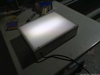 Light box illuminated on work surface
