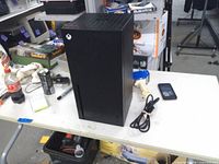 Front and side view of mini fridge with power cord and accessories on table