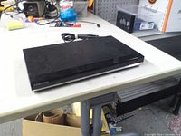 Front and top view of Samsung DVD player on workbench