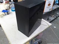 Front and side view of black Samsung subwoofer on table