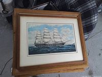 Matted framed print of tall ship on ocean