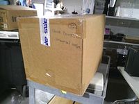 Full view of sealed cardboard case labeled shoe covers