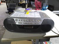 Front view showing Sony boombox with speakers, controls and display