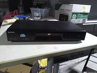 Front view of Sony DVD player showing tray and controls