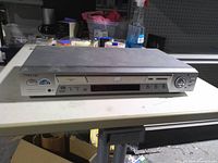 Front view of Sony DVD player showing tray, controls and display