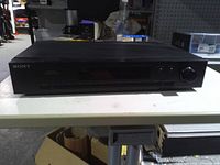Front view of Sony ST-JX311 tuner showing display, controls and branding