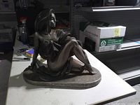 Front view of seated woman sculpture on table