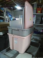 Stacked plastic totes showing colours and lids