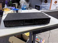 Front view showing TEAC branding, model EQA-220, sliders and spectrum display