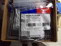 Sealed Tripp Lite adapters inside carton showing model label P134-000