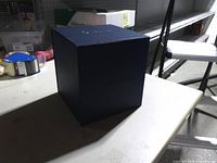 Closed blue collectors box on table