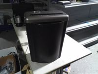 Front view of shredder showing full bin