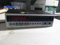 Front view showing LED display, station scale, preset buttons