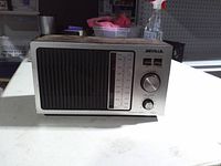 Front view showing Seville logo, tuning scale, knobs, and speaker grille