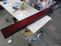 Full view of long rectangular electric sign on table