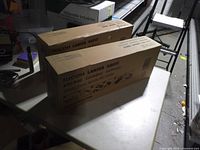 Two sealed boxes marked Ricoh Lanier Savin Waste Toner Bottle IM C6000