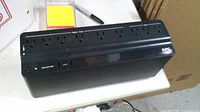 Top/front view showing APC Back-UPS 850, outlets, USB ports, power button