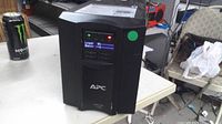Front view showing APC logo, LCD screen powered on