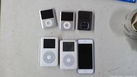 Front view of six iPods showing screens and click wheels