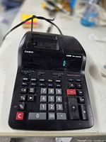Top view of Casio DR-210TM calculator showing keypad, display, and printer area