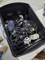 Overview of black tote filled with assorted wired computer mice