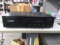 Front view showing Denon branding, tuner display and control knobs