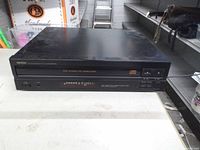 Front view of Denon DCM-320 CD player showing tray and controls