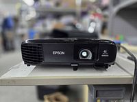 Front view showing Epson branding, lens illuminated
