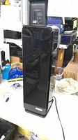 Front view of black GermGuardian tower air purifier with power cord