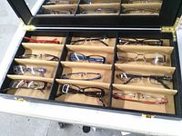 Open display case showing all 12 frames in partitions