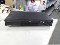 Front view of Hitachi DVD player showing disc tray and control buttons