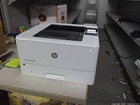 Front and side view of HP LaserJet Pro 4001dn printer powered on