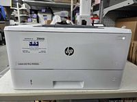Front view showing HP logo, model badge, power button and service sticker