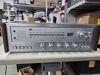 Front view of MX Stereo Receiver 1561 showing faceplate, controls, tuner dial and wood sides