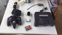Top view of all items: console, controller, power supply, RF adapter, jumper pak, memory card