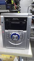 Front view of Panasonic SA-AK333 showing controls and 5-disc changer