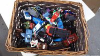 Top view of basket filled with assorted Pixar Cars die-cast vehicles