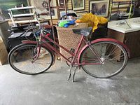 Full left-side view of red step-through bicycle with fenders