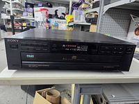 Front view of Sony CDP-C211 showing controls, display, disc tray