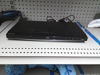 Front view showing Blu-ray logo, tray, control buttons, power cord