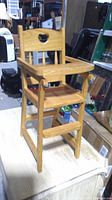 Front angle of wooden doll highchair on table