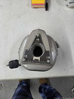 Top view of Electrolux cord rewinder showing housing, front plate, cord and plug