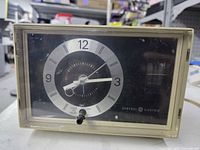 Front view showing clock face, alarm knob, brand marking