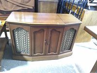 Front view of wood stereo console cabinet with lattice speaker grilles