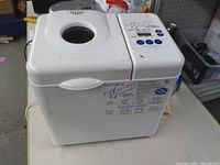 Front and left side view of bread maker showing overall condition