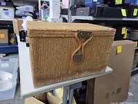 Front and top view of woven chest showing rope handle and latch