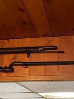Musket barrel with front sight; bayonet alongside